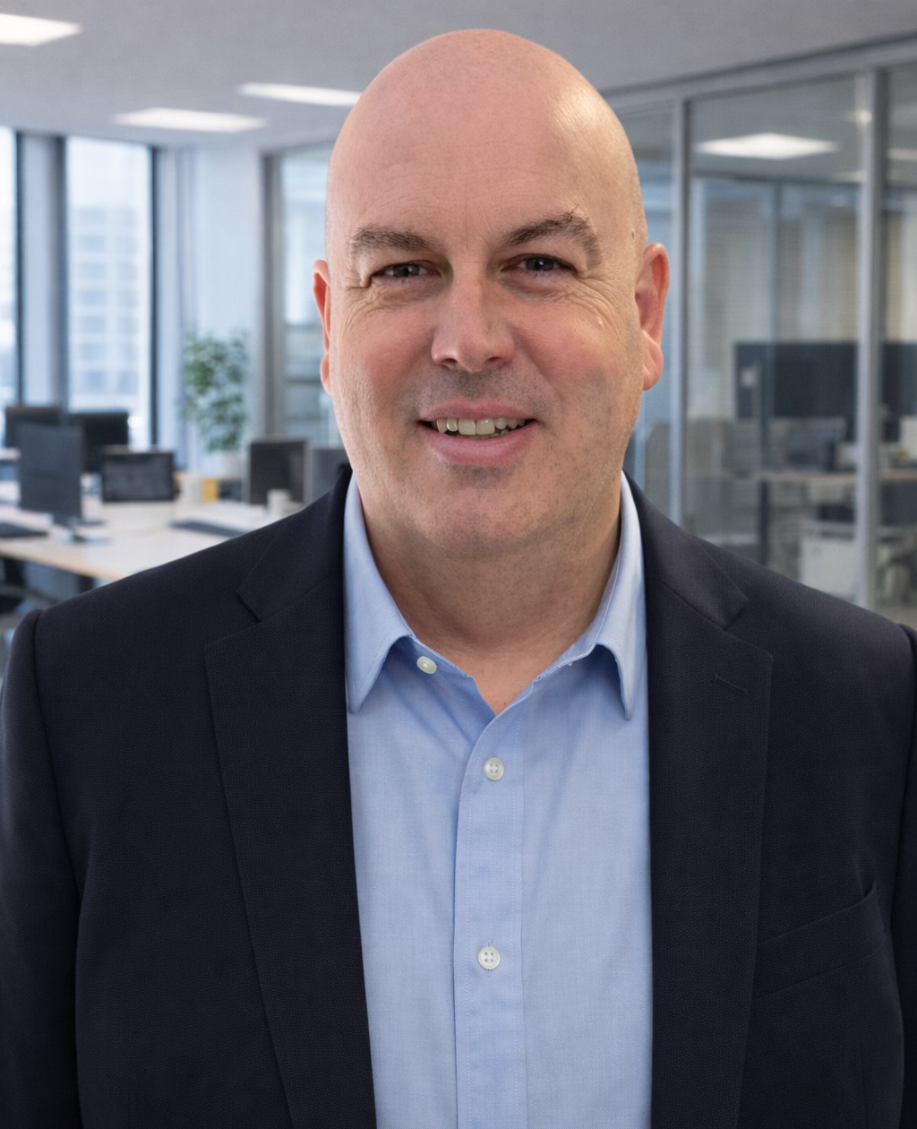 Smiling businessman in office setting.